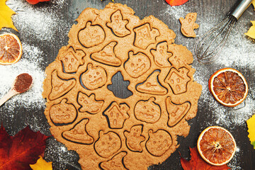 Making homemade gingerbread cookies. Halloween symbols - pumpkin, hat, ghost.