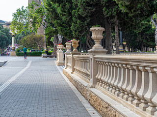 Stone balustrade with flower pots in the park