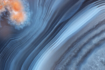 The texture of a beautiful blue striped agate with an orange inclusion. - obrazy, fototapety, plakaty