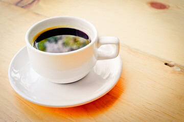 a white cup of coffee on the table With color effect