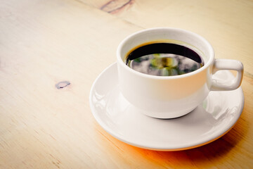 a white cup of coffee on the table With color effect