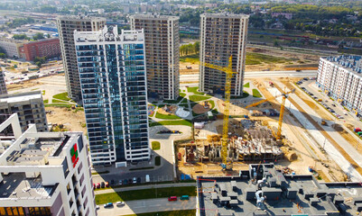 Fototapeta premium Top view of the construction of a new district of the city quarter with residential buildings and business centers. 25 September 2021, Minsk, Belarus