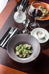 Homemade meat dumplings with parsley russian pelmeni and vodka shot and red wine on the table