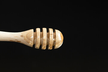 honey dripping from a wooden spoon