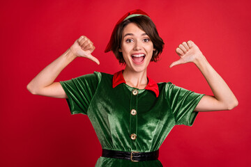Photo of excited funky lady direct thumb fingers herself wear elf costume hat isolated red color...