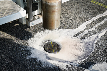 Core cutter machine cutting the asphalt with drill.