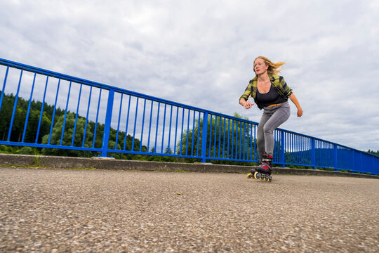 Young woman inline skating across&not;&dagger;Remsbrucke&not;&dagger;bridge