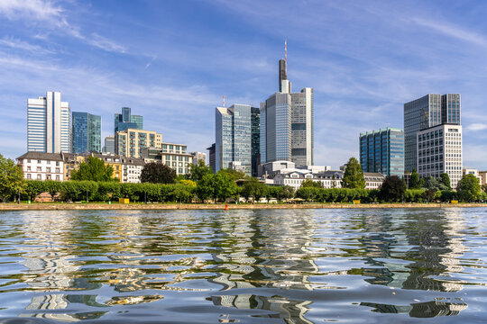 Germany, Hesse,¬†Frankfurt, Clear surface of Main river with city skyline in background