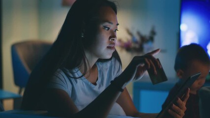 Mother making online purchases at night