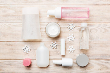Makeup products and Christmas decorations on color background. Top view New year Beauty concept