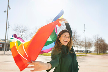Happy lesbian woman holding rainbow flag