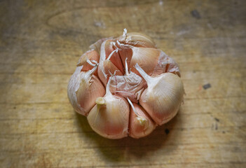 Fresh garlic on a cutting board on wooden background