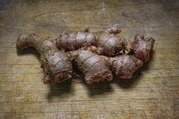 Red ginger on a wooden cutting board. selective photo of ginger spice on a wooden board