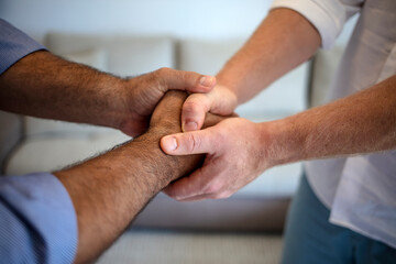 Close Up shot of two unrecognisable business people shaking hands in an office. Image business mans handshake. Business partnership meeting concept. Cropped shot of two businessmen shaking hands.