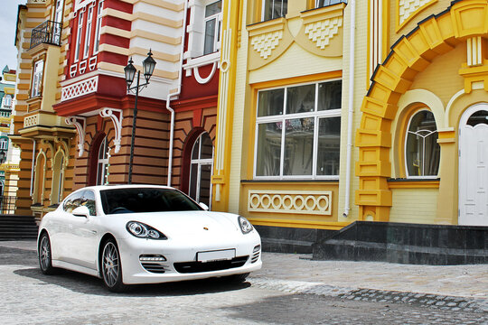 Kiev, Ukraine - June 1, 2013: Porsche Panamera among beautiful buildings. White Porsche