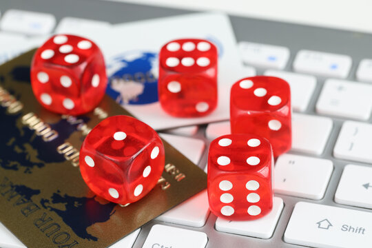 Dice plastic credit bank cards and computer keyboard on table