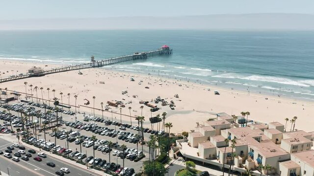 Cinematic view on scenic pier in Manhattan Beach, California USA on sunny summer day. Perfect summer background with copy and text space on blue ocean and white sandy beach. Ideal californication 4K