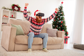 Photo portrait bearded man wearing 3d glasses watching virtual reality gesturing like winner sitting on sofa at home