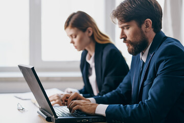 colleagues in the office in front of a laptop career network officials