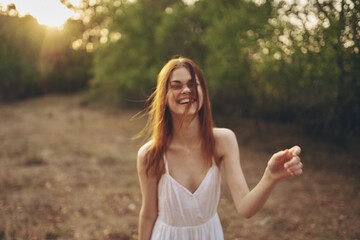 cheerful woman outdoors in the field freedom lifestyle