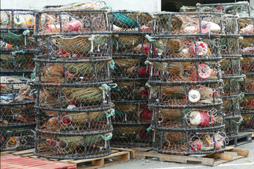 Round wire net crab pot traps packed in harbour, fishing and seafood concept