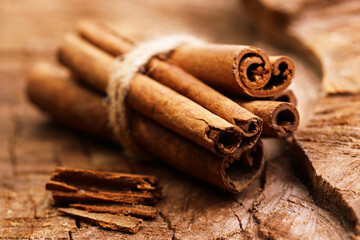 Cinnamon sticks on a wooden background