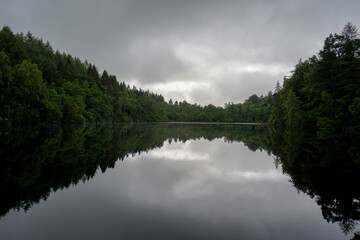 Grey and gloomy sky over a loch in Scotland 