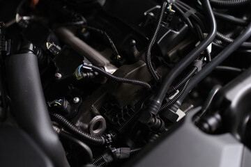 Fototapeta na wymiar Closeup of electronics and engine under hood of car