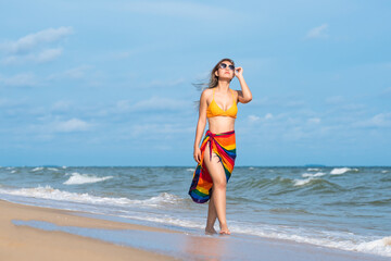 Asian beautiful girl in a sexy bikini standing on the beach in summer.
