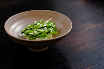 Dish of cottage cheese and garden greens with flowers made at a restaurant