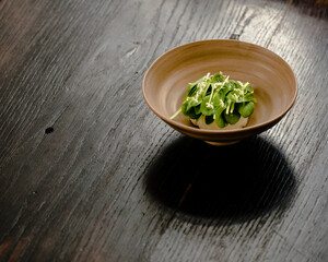 Dish of cottage cheese and garden greens with flowers made at a restaurant
