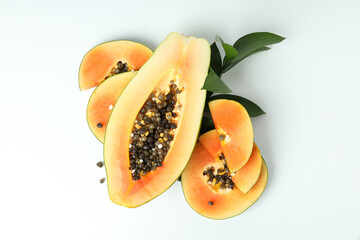 Fresh ripe papaya with leaves on white background
