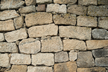 Old white stone wall  closeup in sunny day