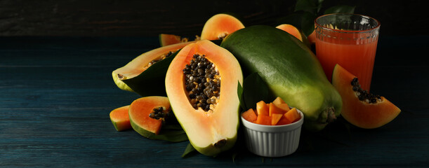 Fresh papaya and juice on wooden table, space for text - obrazy, fototapety, plakaty