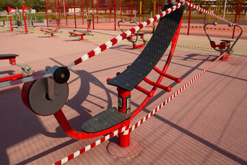 Public gym is wrapped in striped red and white warning tape. Restrictions due to coronavirus....