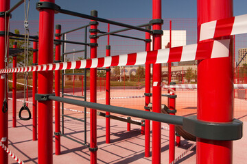 Public sports ground is wrapped with barrier tape. Outdoor sports ground is closed during the COVID-19 pandemic. Lockdown due to coronavirus.