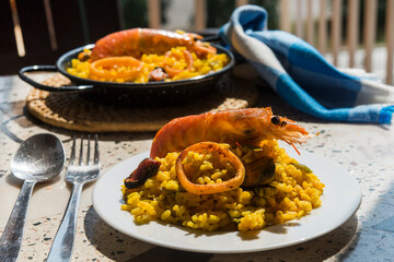 Paella typical spanish food in granite background