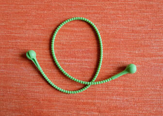 Green silicone cord for fasteners. Ribbon for pulling bouquets