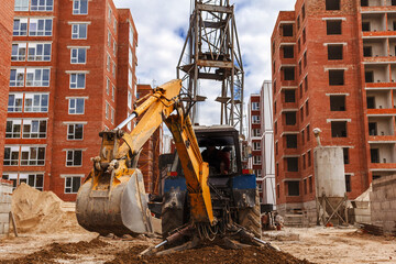 construction site with construction machinery, Excavator, Сrane on construction site with buildings in background,selective focus