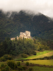 Scenic ruins of ancient castle Likava outside on blue cloudy sky background. Liptov region. Slovakia. Tourist attraction, tourism destination. Slovak historical castles, chateaus and churches.