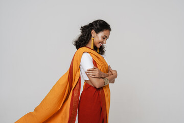 Young south asian woman smiling while posing in sari