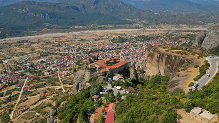 Fototapeta premium Aerial drone photo of iconic Holy Trinity Monastery at Meteora monasteries complex of immense natural pillars and hill-like rounded, an Unesco World Heritage site, Western region of Thessaly, Greece