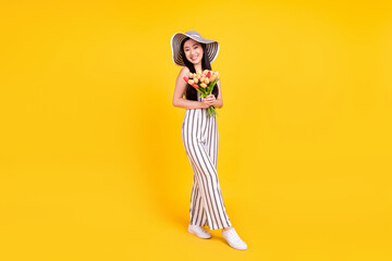 Full length body size photo woman smiling keeping bouquet wearing casual outfit isolated bright yellow color background