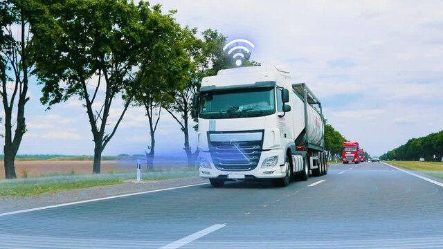 Concept of a futuristic self-driving truck. A large modern truck drives along the highway, scanning the road with security systems. Security system in cars