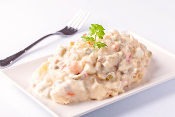 Ensaladilla rusa, potato salad with mayonnaise on white background 