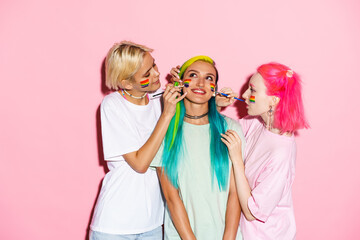 Young three women smiling while making rainbow makeup