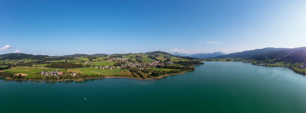 Austria, Upper Austria, Zell am Moos, Drone panorama of village on shore of Irrsee lake in summer