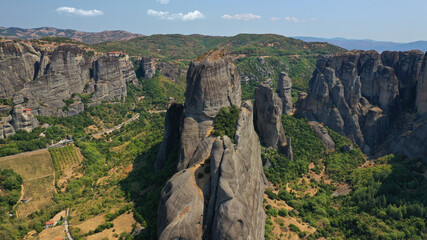 Aerial drone photo of iconic Meteora rock formation complex of immense natural pillars and hill-like rounded stones, an Unesco World Heritage site, Thessaly, Greece