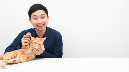 Man with lovely cat orange color cheerful on the table copy space