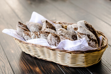 Small rye bread loafs in a basket at a restaurant